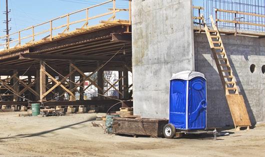 portable restrooms stacked at a busy job site